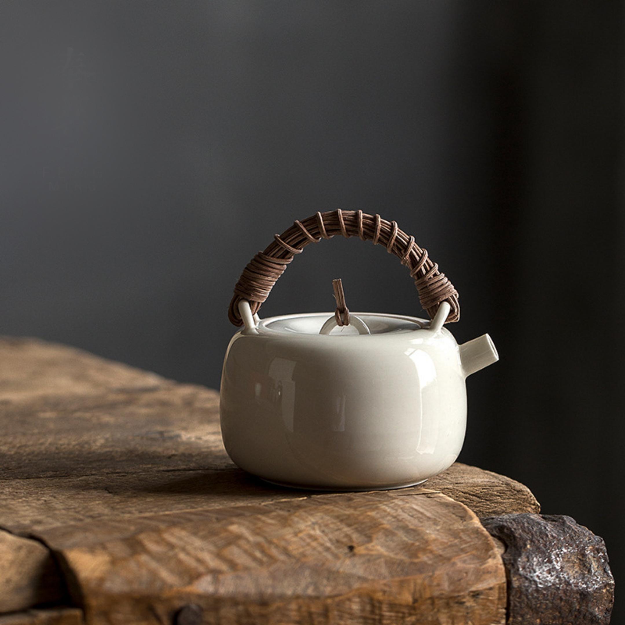 https://www.cnteaspirit.com/wp-content/uploads/2022/11/Rattan-Handle-Milky-White-Ceramic-Kung-Fu-Teapot-1.jpg